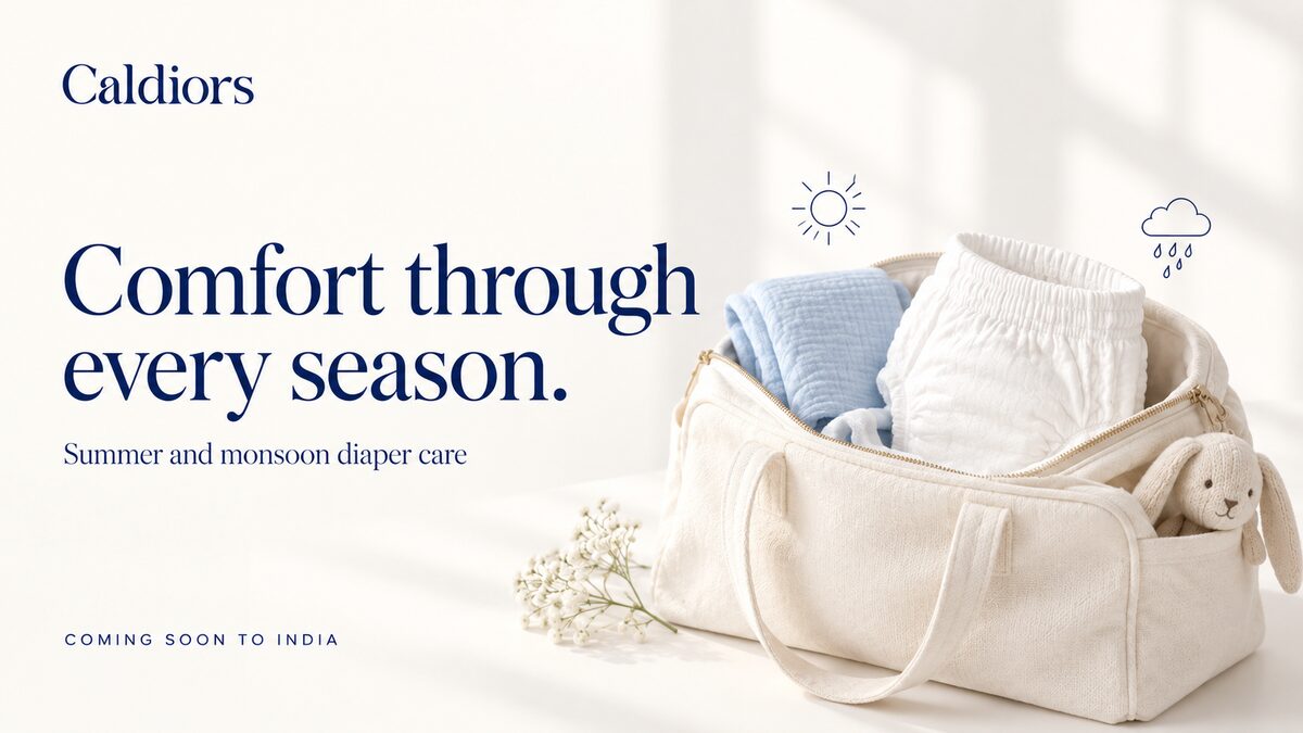 Caldiors 'Comfort through every season' – a cream changing bag packed with a pant style diaper and blue muslin, with sun and rain icons